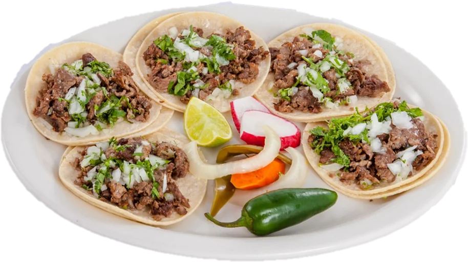 A plate of street tacos with lime and radish